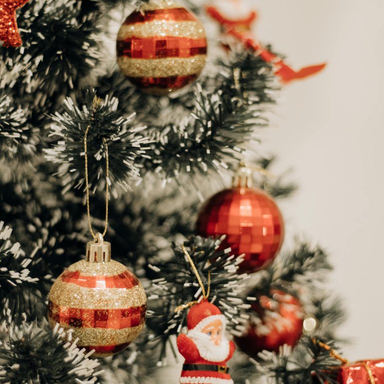 Close-up of a decorated Christmas tree with red ornaments in São Paulo, Brazil.